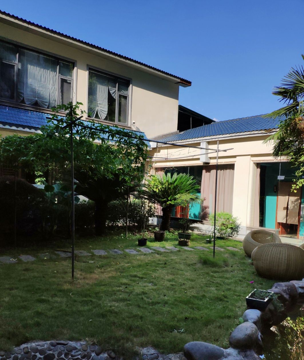 A residential property with a well-maintained garden, a patio area, and a garage.
