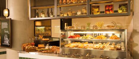 A buffet area with various food items and a display of bottles.
