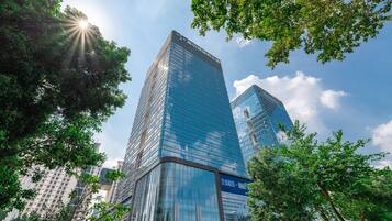 Standing tall in the heart of the city, this sleek building offers a striking blend of urban and natural surroundings.