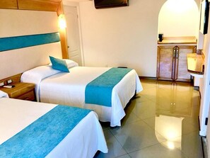A hotel room with two beds, a wooden headboard, a nightstand, a desk, and a mirror. - Hotel Blue Star Cancun (Cancun)