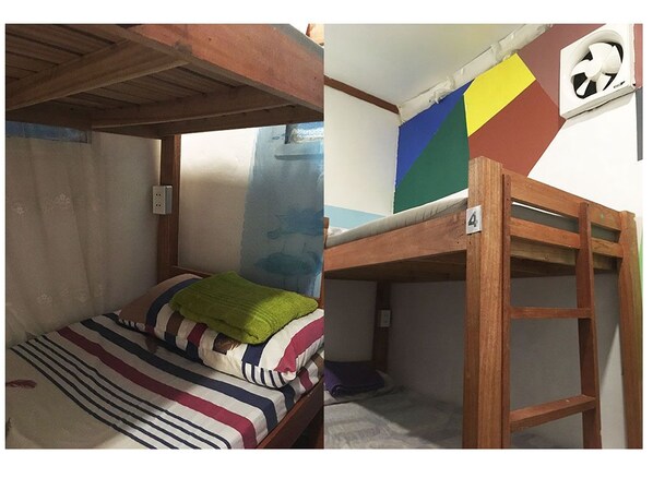 A bunk bed with a striped bedspread and a green blanket. There is a ladder attached to the bunk bed. - J's Backpackers Hostel (Davao)