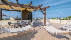 A rooftop terrace with a wooden pergola, outdoor seating, and hammocks. - 3 bedroom nice apartment in Bari (Bari)