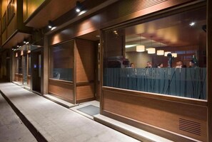 A modern building with large windows and a wooden facade. - Hotel Marcial (Naron)