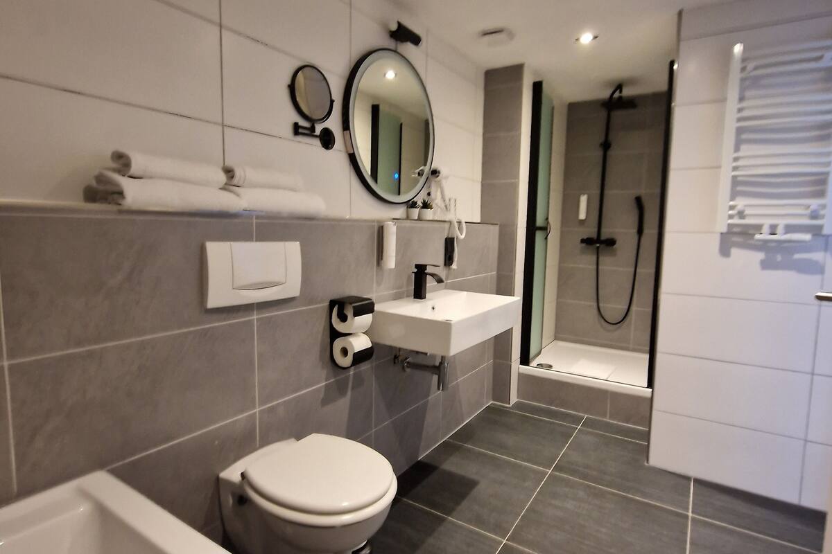 deluxe double room | bathroom | shower, hair dryer, towels, soap