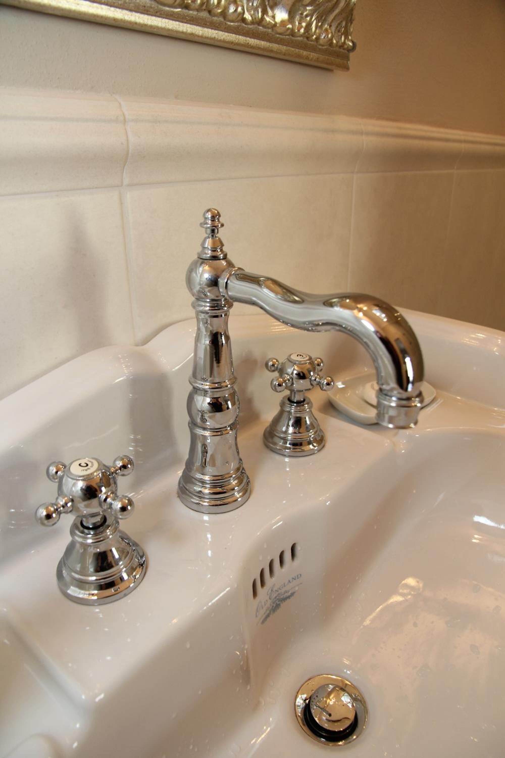 A bathroom sink with a vintage-style faucet and a single-handle design.