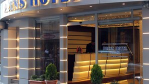 The exterior of the Drens Hotel in Istanbul, featuring a modern facade with illuminated signage and a reception area visible through the glass. - Prens Hotel (Istanbul)