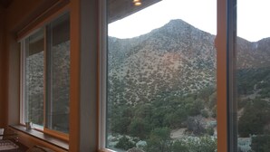 A room with large windows overlooking a mountainous landscape. - Casita Canoncito--private suite with kitchenette (ALbuquerque)