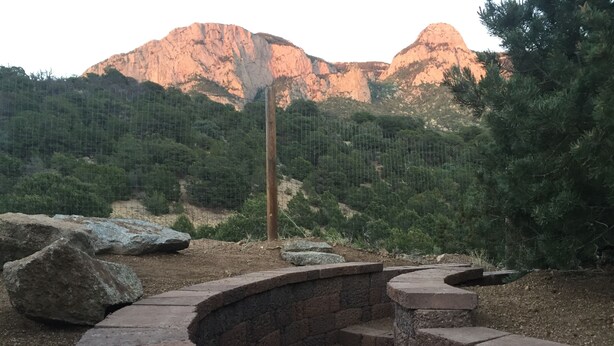 A stone staircase leading up to a viewing platform with a metal fence and trees in the background. - Casita Canoncito--private suite with kitchenette (ALbuquerque)
