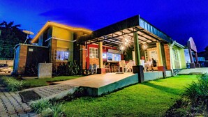 A two-story building with a covered patio area, outdoor seating, and a well-maintained lawn. - Frontiers Hotel Entebbe (Entebbe)