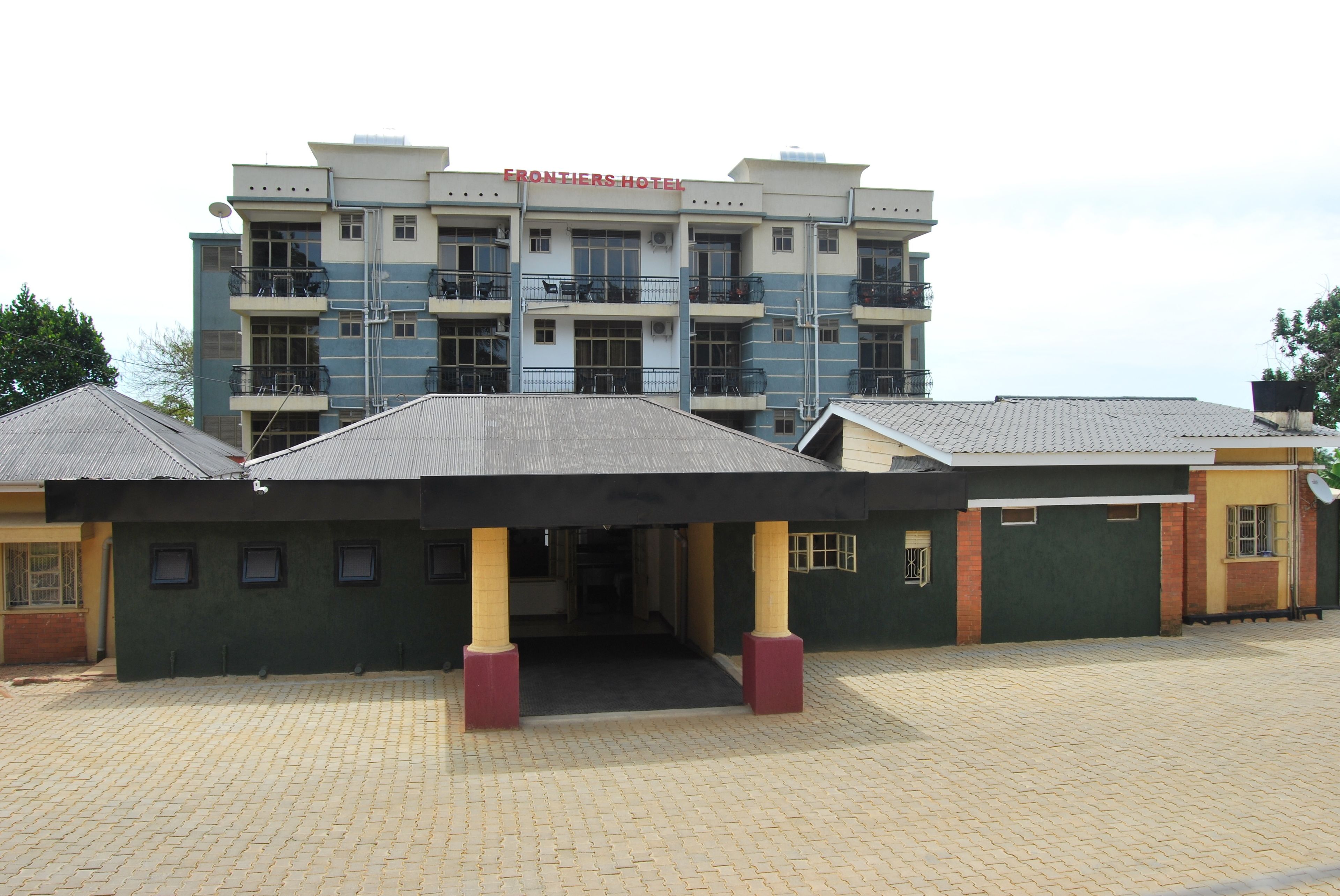 A hotel with a multi-story structure, a covered entrance, and a paved driveway.