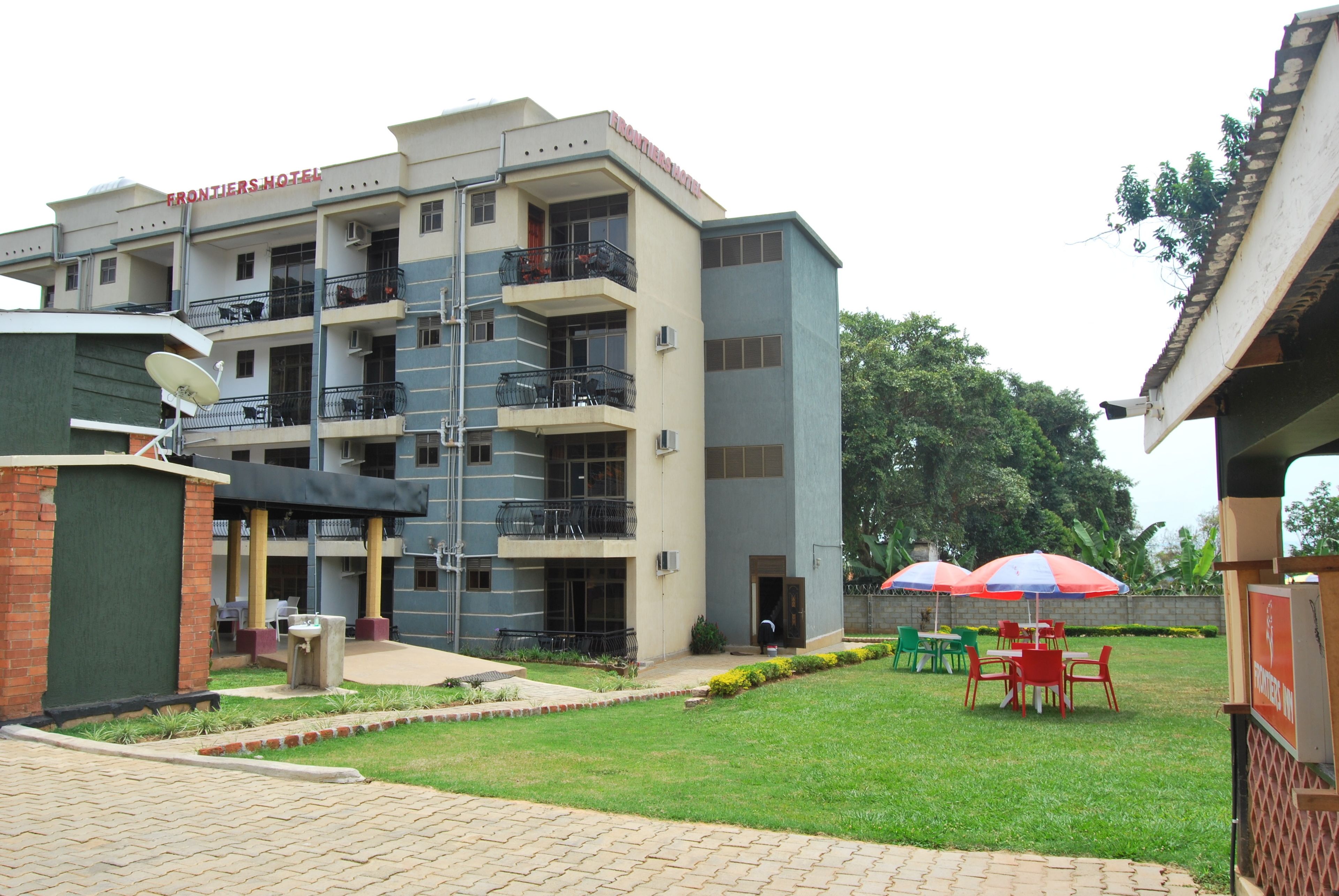 A hotel with multiple floors, balconies, and outdoor seating areas.