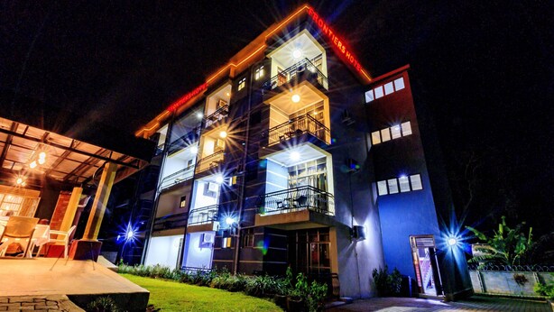 A multi-story hotel with balconies and a well-lit entrance. - Frontiers Hotel Entebbe (Entebbe)