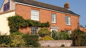 A traditional brick building with a sign reading "Bird in Hand Free House & Restaurant".