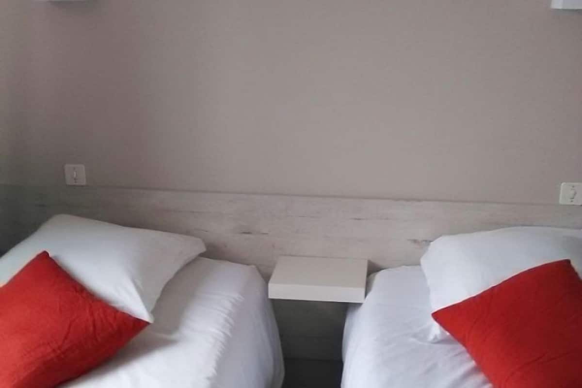 Habitación con 2 camas individuales | Cortinas blackout, cunas, wifi gratis y decoración personalizada