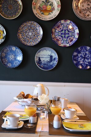 A breakfast table with plates, cups, and a pitcher. - Hotel Restaurant Weinlaube (Koblenz)