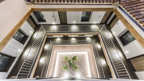 A modern interior with a central light feature, a tiled ceiling, and a staircase. - Intelier Casa de Indias Hotel by Intelier Hotels & Suites (Seville)