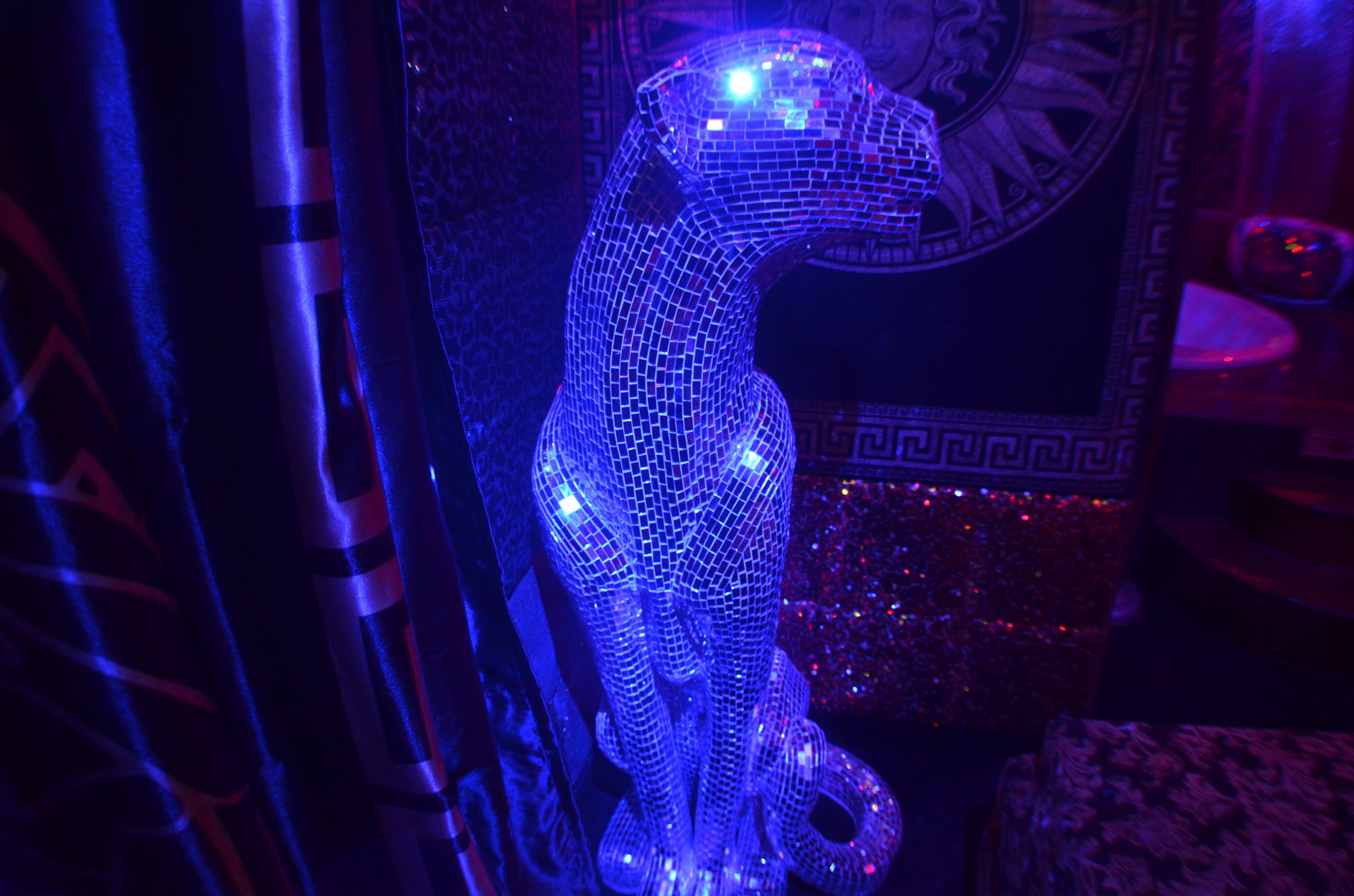 A statue with a mosaic pattern, possibly in a public or historical building.