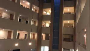 A multi-level hotel interior with balconies, a central elevator, and a staircase. - Selahaddin Eyyubi Uygulama Oteli (Istanbul)