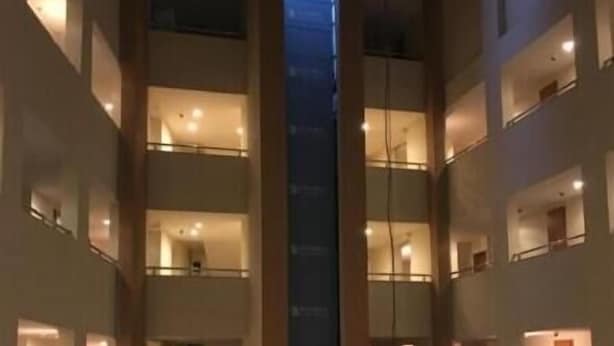 A multi-level hotel interior with a central elevator shaft, multiple balconies, and a modern design. - Selahaddin Eyyubi Uygulama Oteli (Istanbul)