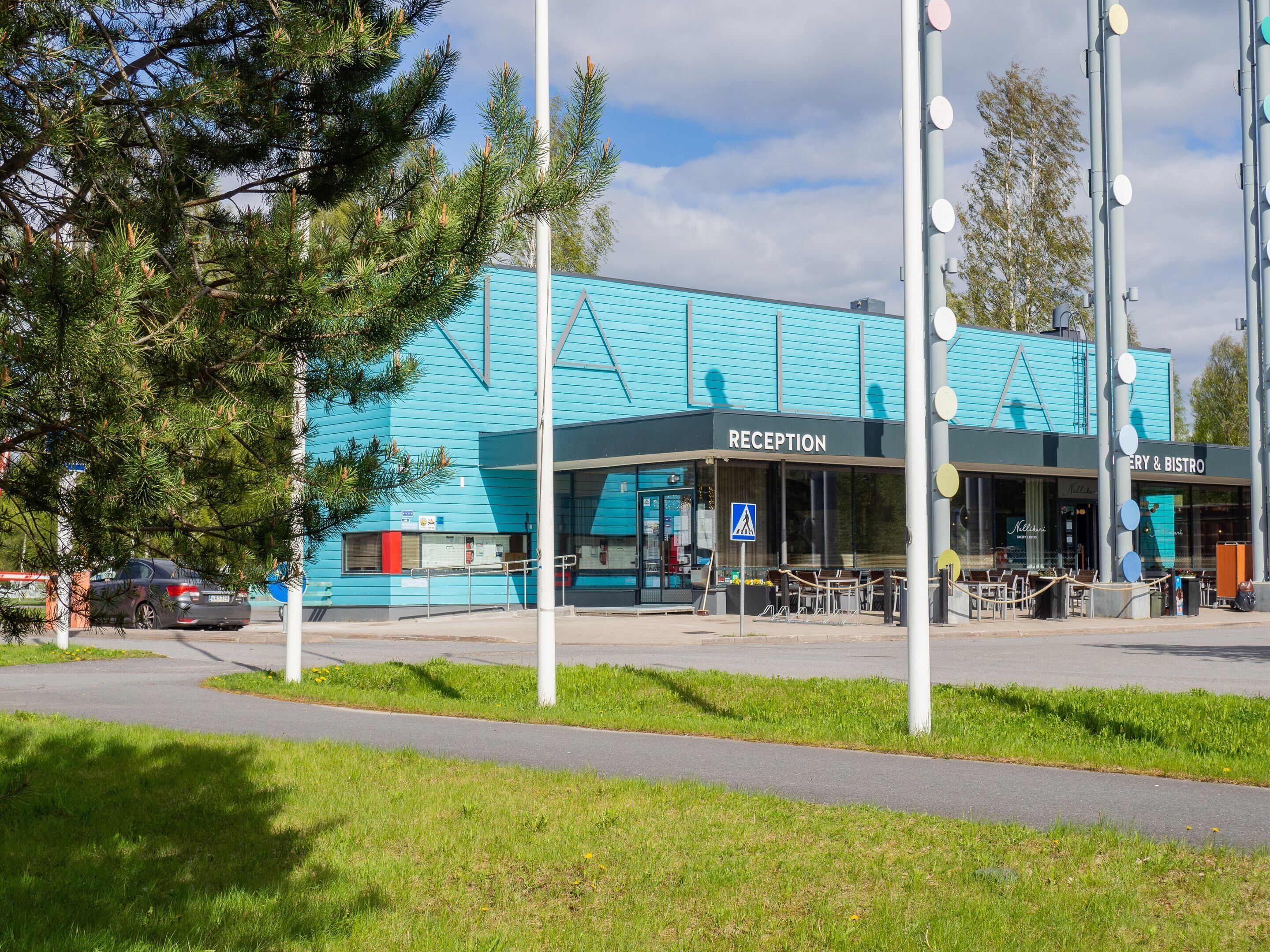 Un bâtiment comprenant un espace d’accueil et un restaurant appelé « RECEPTION & BISTRO ».