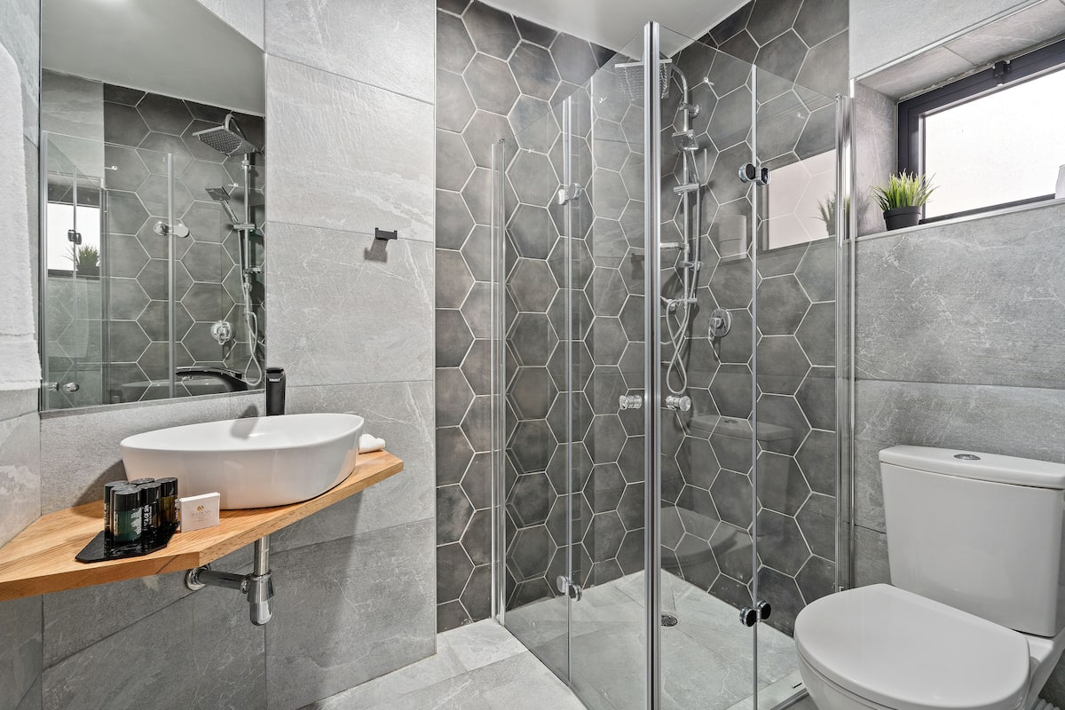 luxury studio suite, 1 king bed with sofa bed | bathroom | shower, rainfall showerhead, free toiletries, hair dryer