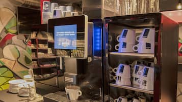 A coffee machine with a digital display and a coffee cup.
