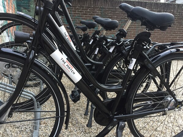 A row of bicycles with a white label that reads "THE MATCH".