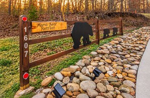 A wooden fence with a bear silhouette and a sign that reads 'Mama Bear Retreat.' - Hot Tub, Fire Pit, Views, Wheelchair Accessible Retreat (Sevierville)