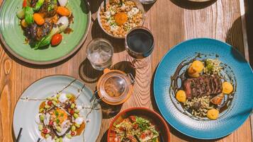 A dining table with various dishes and drinks.