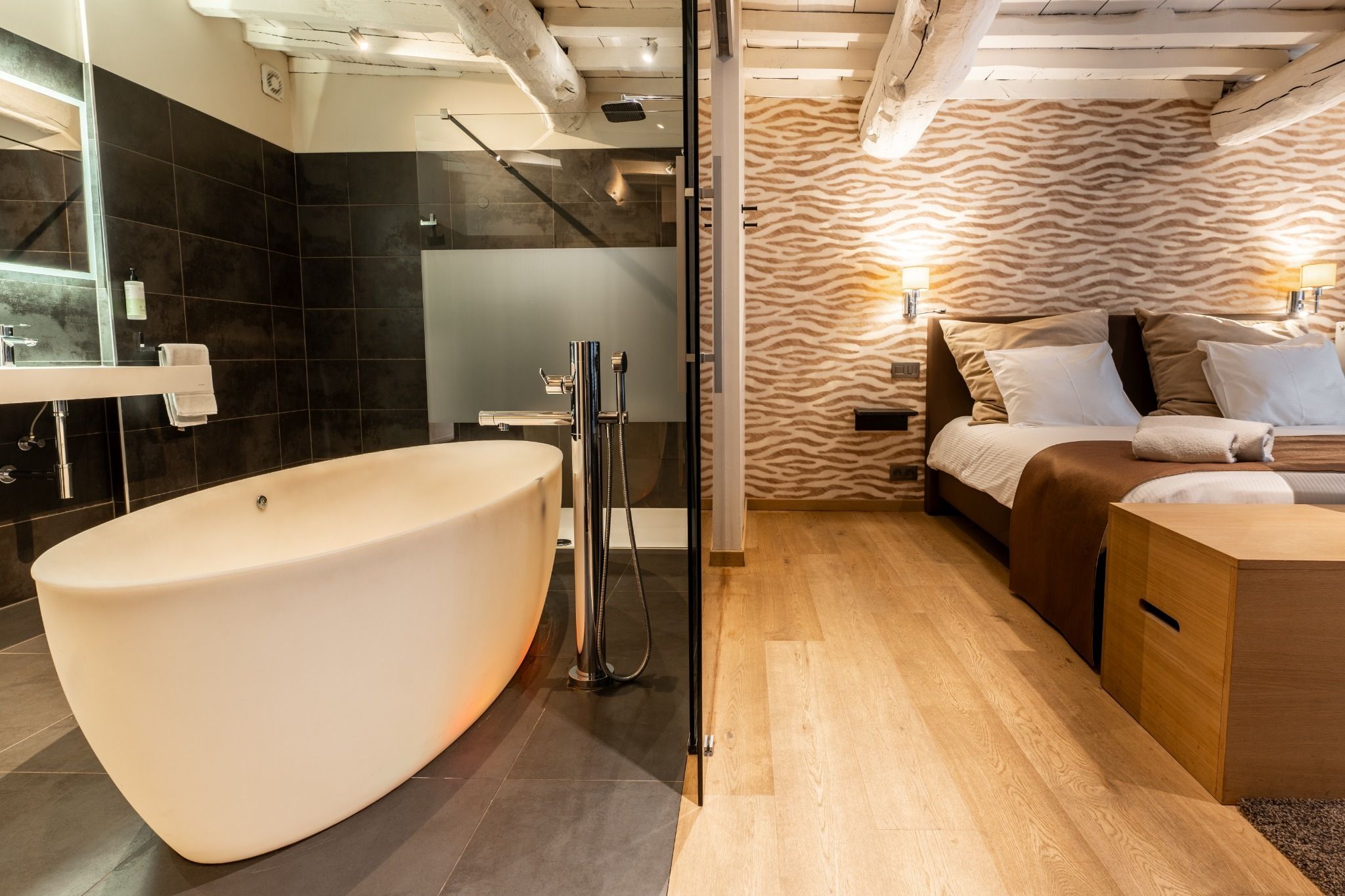 A modern bathroom with a freestanding bathtub, a shower, and a vanity with a mirror.