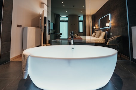 Suite | Premium bedding, memory foam beds, desk, blackout drapes. Le Manoir