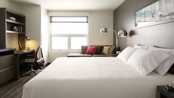 A hotel room with a large bed, a desk with a chair, a bookshelf, and a window.