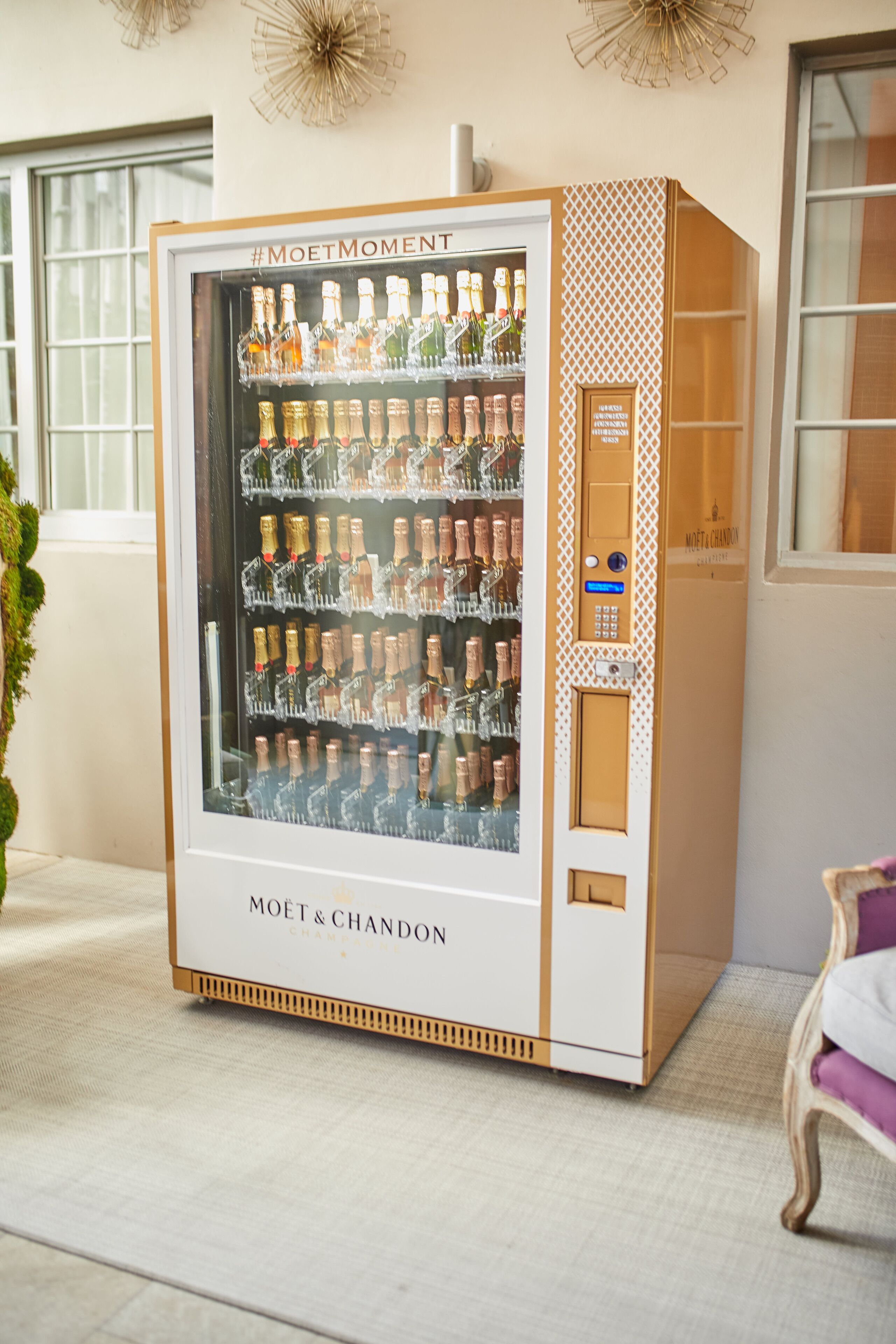 A Moët & Chandon champagne vending machine with multiple bottles of champagne.