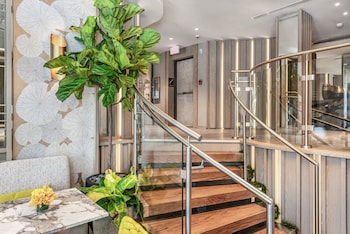 A hotel with a curved facade, large windows, and a prominent entrance. at Lennox Hotel Miami Beach