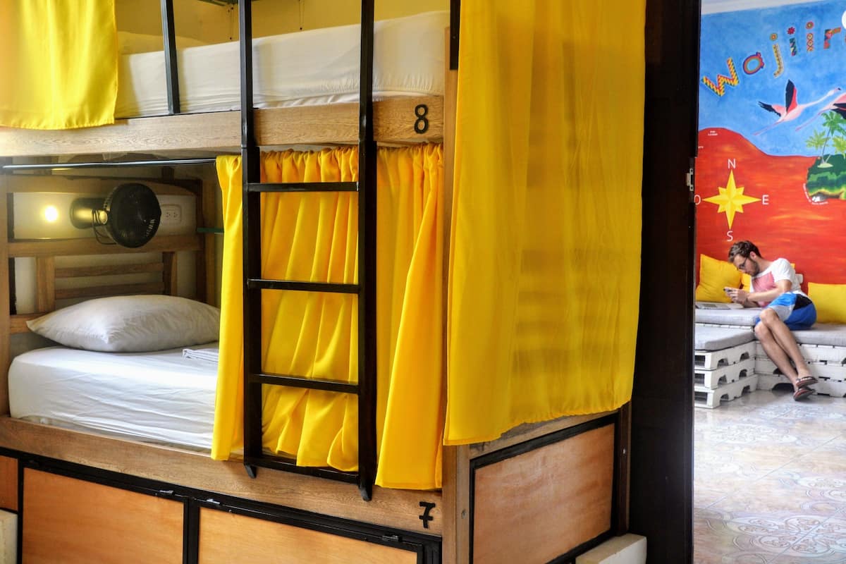 A bunk bed room with yellow curtains and a number '8' on the wall.