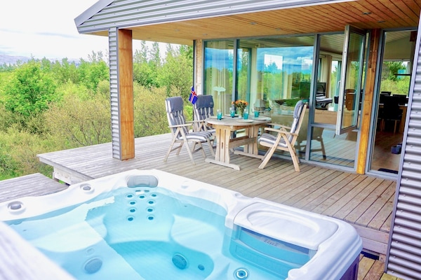 Main House.Wrap around patio, with a hot tub,outdoor shower and patio furniture.