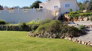 A white building with a balcony and a stone wall. - Beautiful villa, with private pool, set in hills with spectacular views  (Loule)