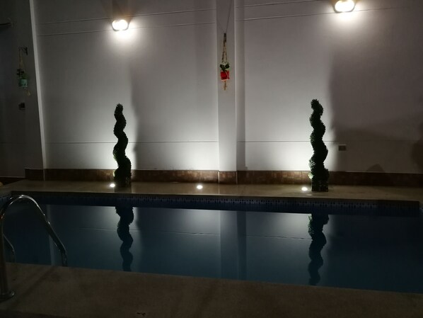 Una piscina al aire libre, tumbonas