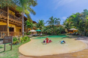 A resort with a pool area, including a sign indicating the depth of the pool and a sign for a spa.