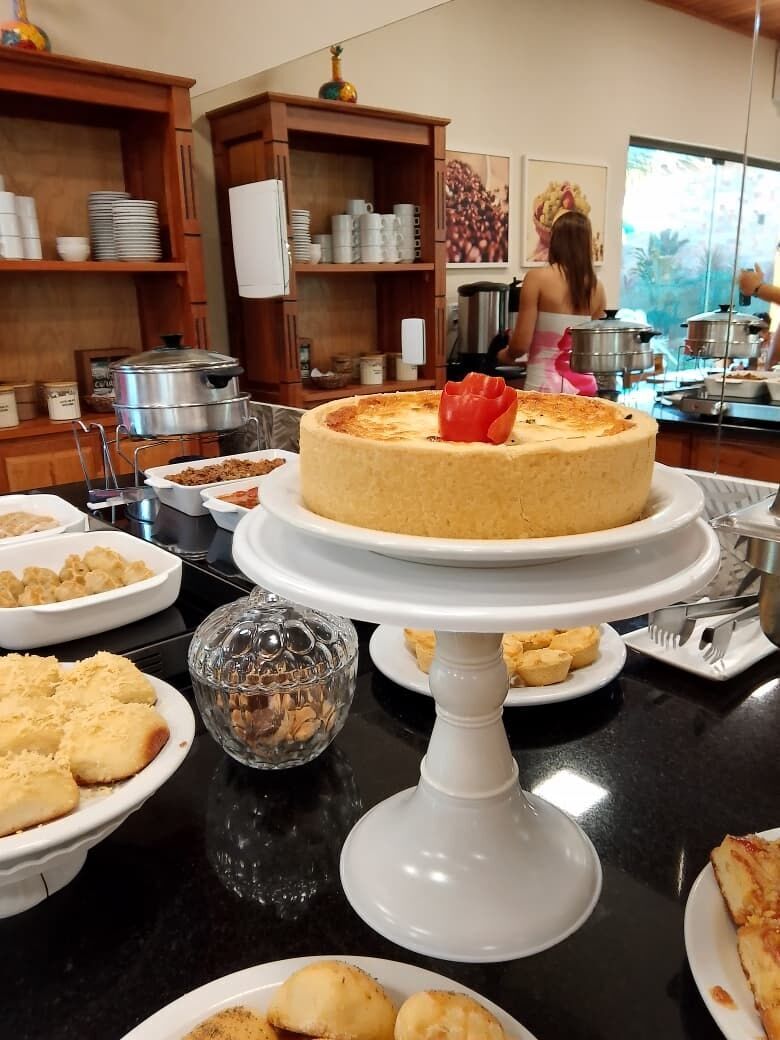 A buffet setup with various dishes and a cake centerpiece.