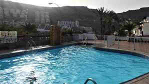 A swimming pool with a view of a residential area and hills in the background. - Cozy apartment with sea views, Playa del Cura, Jardin Paraiso  (MOGAN)