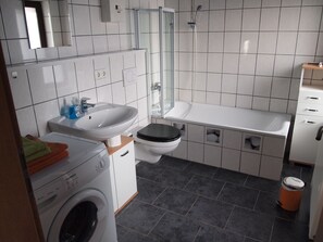 Bathtub, hair dryer, towels, soap