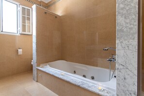 Bathtub, hair dryer, bidet, towels