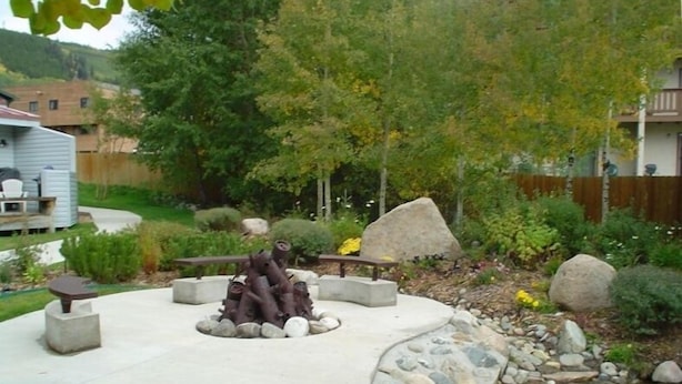 A patio area with a fire pit, seating, and a small pond. - Affordable Luxury in the Mountains (Dillon)