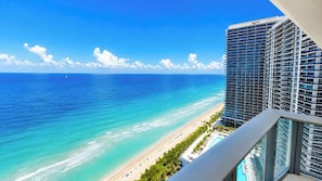 A high-rise hotel with a view of a beach and ocean.