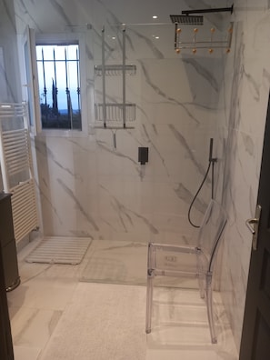 Shower, hair dryer, towels, toilet paper