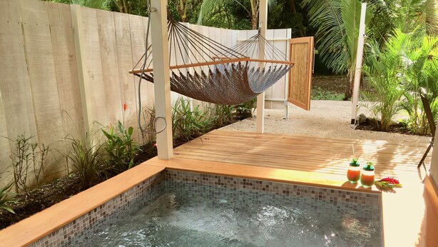 A swimming pool with a wooden deck and a hammock. - El pasito is the place where you feel good at once (POTRERO)