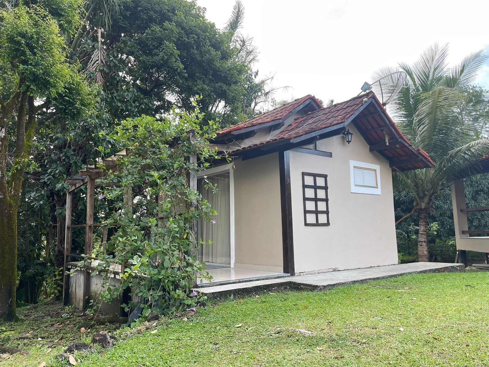 A small, single-story building with a tiled roof, a window, and a door.