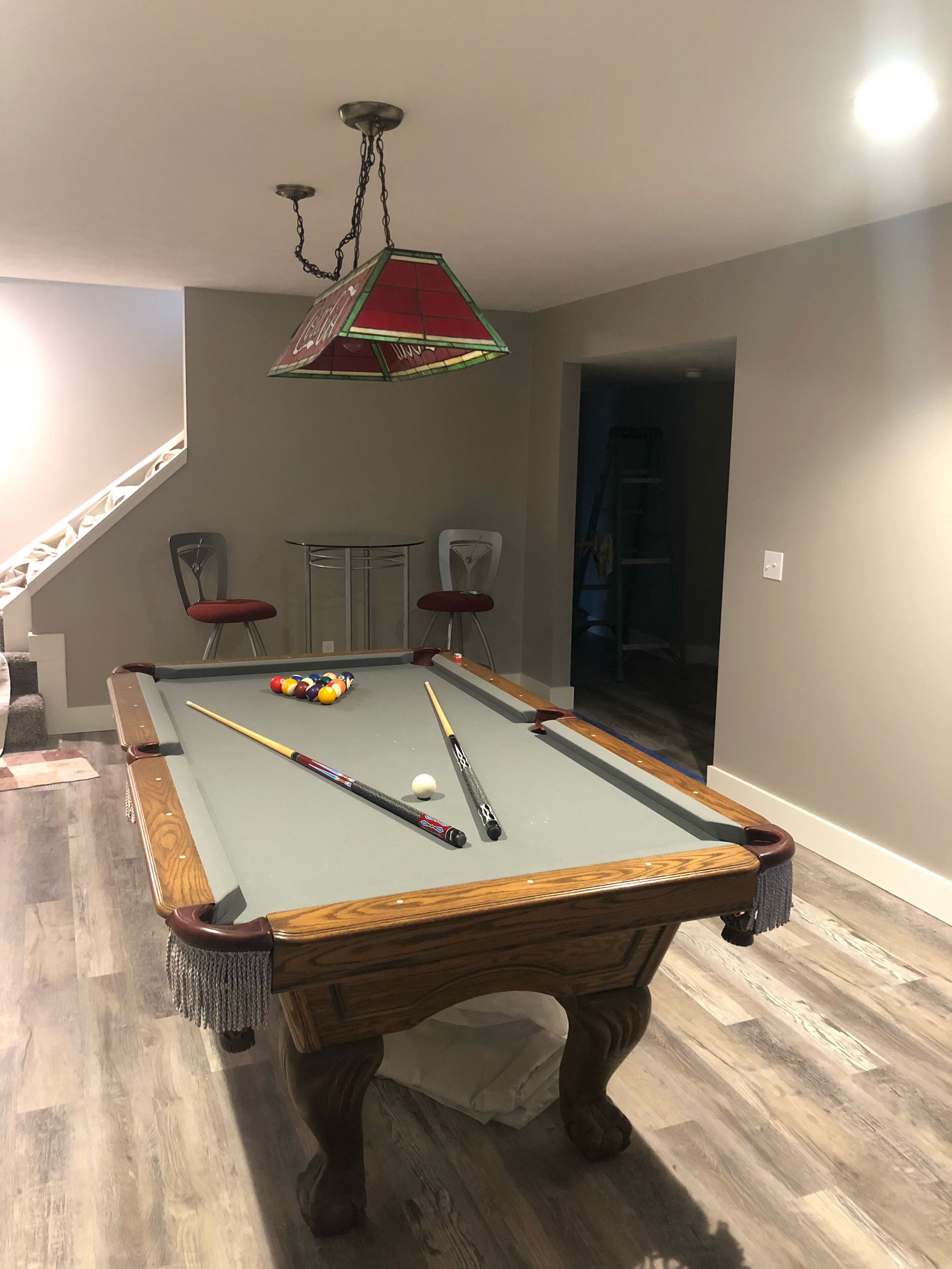 Lower level with pool table, TV and couch 