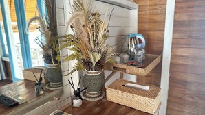 A wooden interior with a kitchen counter, a coffee maker, a kettle, and a bottle of water. - Sunset Hill Penida Resort (Penida Island)